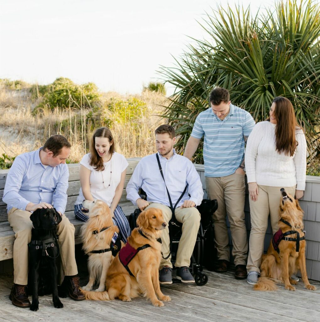 group of four assistance dogs in service vests with group of five handlers who learned how to get a service dog