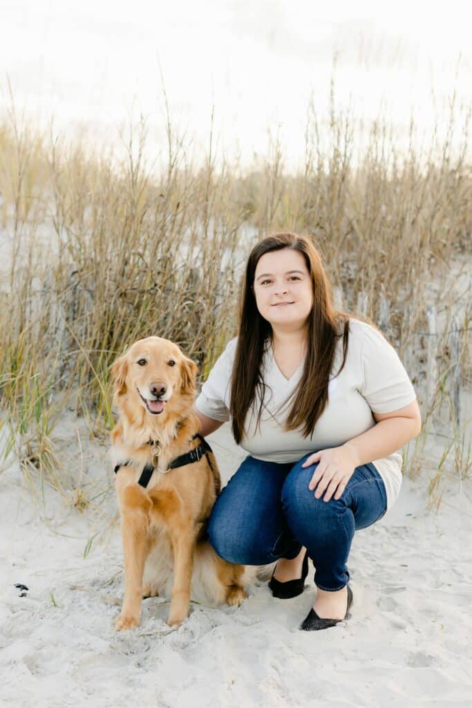 paws4people team member Bailey Moore with golden retriever dog in service vest