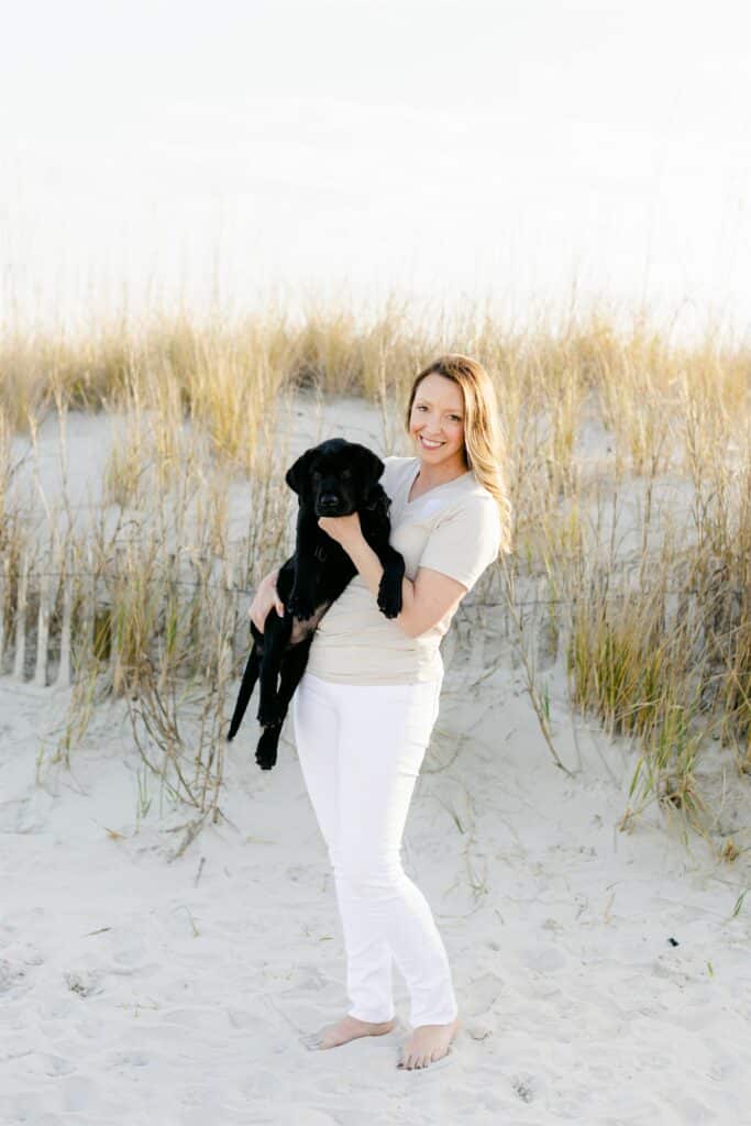 paws4people founder Kyria Henry Whisenhunt with black lab puppy