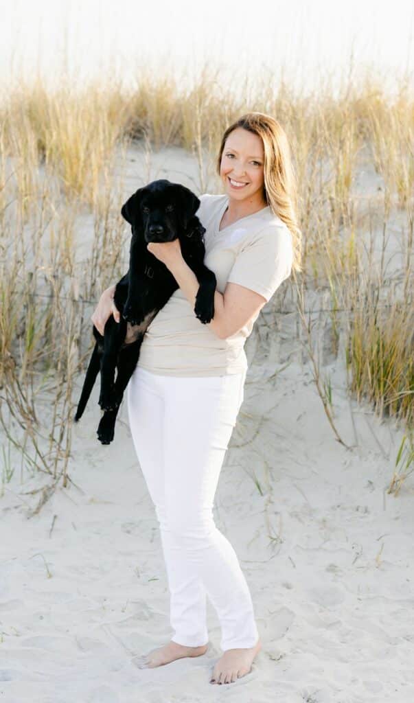 paws4people founder Kyria Henry Whisenhunt with black lab puppy