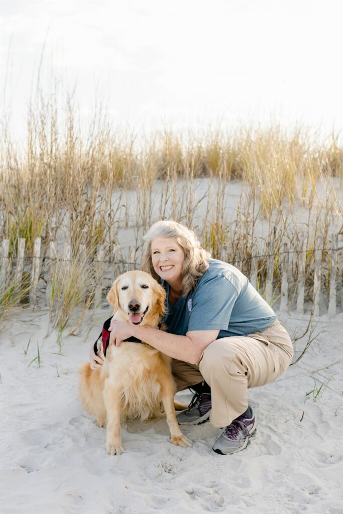 paws4people team member Renee Johnson with yellow lab dog in service vest